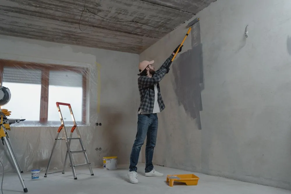 A painter applying paint to an interior wall